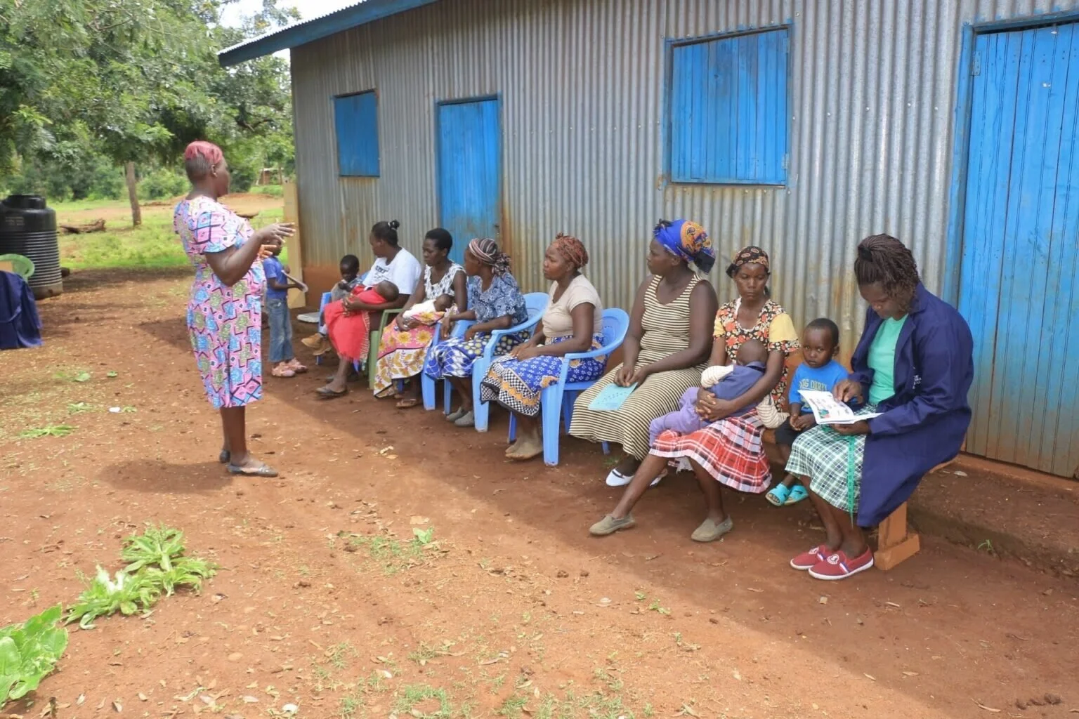 Community health worker educating villagers about hygiene
